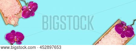 Purple Orchids With Bowl Of Sea Salt With Seashell On Blue Background. Banner. Beauty And Spa. Copy 