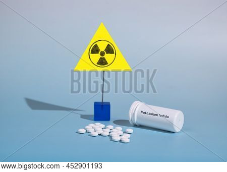 Potassium Iodide Tablets For Use In Case Of Radioactive Contamination And Radiation Sign On A Blue B