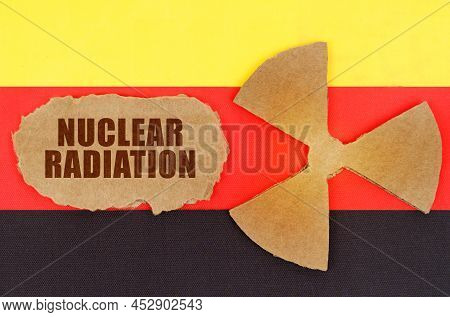 The Concept Of Industry And Radiation. On The Flag Of Germany, The Symbol Of Radioactivity And Torn 