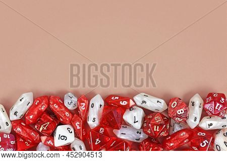 Different Red Roleplaying Rpg Dice At Bottom Of Beige Background With Blank Copy Space