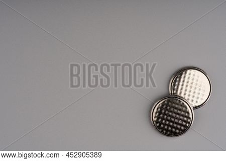 Round Batteries On A Gray Background. Closeup. Space For Text