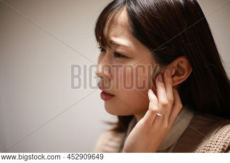 A Woman Who Feels Uncomfortable In Her Ears