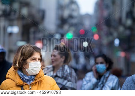 Bordeaux, France - February 24 2022: Selective Blur On Old Woman With Facemask, Walking In The Crowd