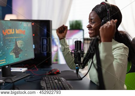 Happy Excited Pro Gamer Woman Raising Hands After Winning Space Shooter Game Competition. Successful