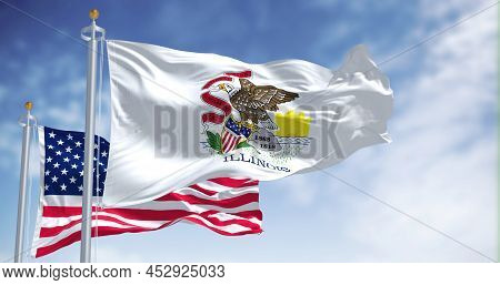The Illinois State Flag Waving Along With The National Flag Of The United States Of America. In The 