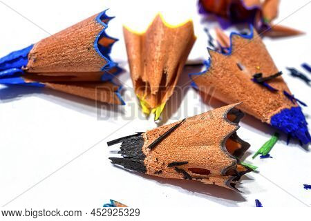 Wooden Shavings Of Colored Pencils On A White Background. Fine Shavings And Pencil Fragments