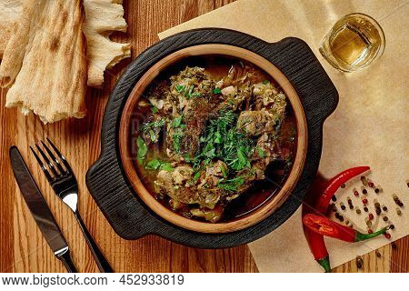 Georgian Veal Chakapuli With Fresh Greens Served In Clay Ketsi