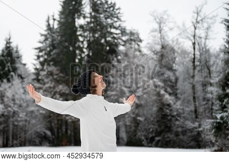 Happy Peaceful Young Woman Standing Outside In A Snowy Winter Nature Enjoying Life With Her Arms Spr