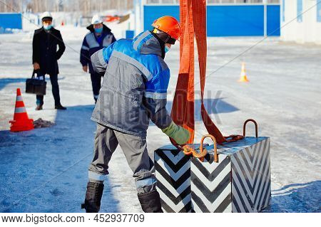 Working Slinger Passes Exam On Lifting Loads. Real Scene. Commission Evaluates Skill Of Slinger. Wor