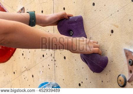 Close Up Mountaineer Holding Grips On Climbing Artificial Rock.