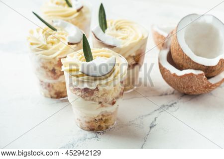 English Layered Dessert Trifle Of Buscuit Dough, Custard And Whipped Cream With Fresh Coconut Pieces