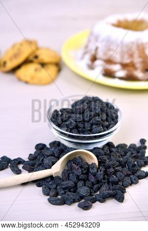 Cookies And Muffin With Raisins In A Bowl, On A Wooden Background, Baking. Vertical Frame