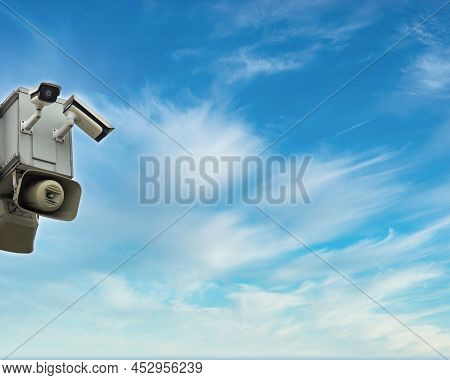 Cctv Security Surveillance Camera And Horn Speaker Against Blue Sky Background With Copy Space