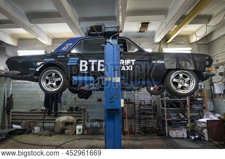 Saint Petersburg, Russia - April 08, 2022: Black Custom Volga Gaz-24 On A Car Lift. Side View