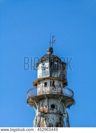 The Old Lighthouse Against The Blue Sky