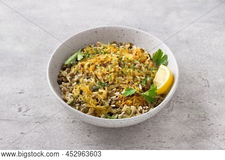 Traditional Middle Eastern Dish, Mujadara Of Lentils, Rice And Fried Onions With Lemon And Herbs On 