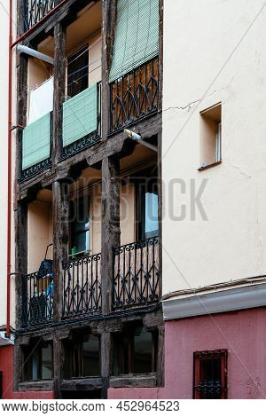 Low Angle View Of Old Cast Iron Balconies Of Old Residential Building In Lavapies Quarter In Madrid