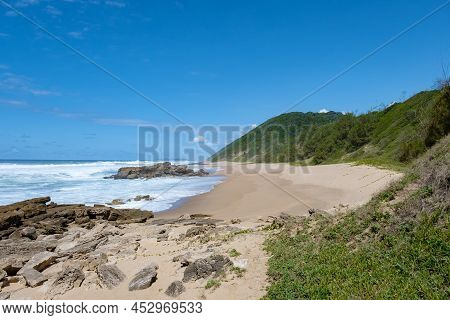 St Lucia South Africa, Rocks Sand Ocean, And Blue Coastal Skyline At Mission Rocks Beach Near Cape V