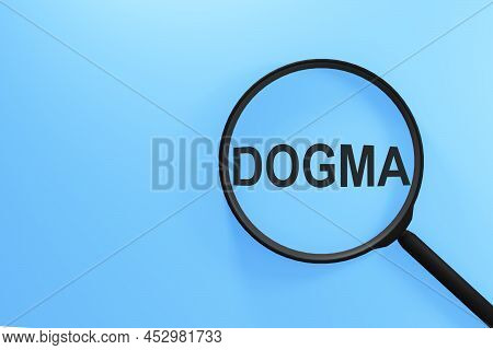 Magnifying Glass With The Inscription Dogma On A Blue Background.