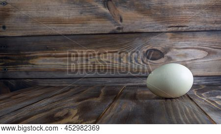 Araucana Egg On Wooden Background. Light Blue Egg From Araucana Chicken. Easter Festival Concepts. E