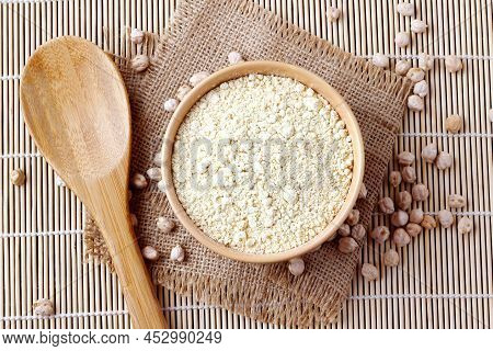 Organic Chickpea Flour In Bowl Over Rustic Wooden Table. Gluten Free