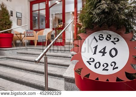 Pot Plant With Anniversary Celebration Sign At Entrance Of Chalet Restaurant