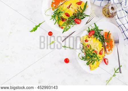 Omelette With Tomatoes, Cheese, Ham And Sandwich Wich Red Cavier On Plate. Frittata - Italian Omelet