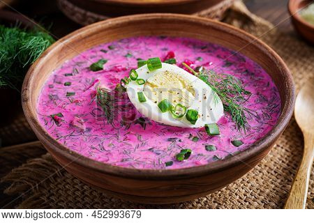 Cold Borscht, Summer Beet Soup With Fresh Cucumber, Boiled Egg And Baked Potatoes On Wooden Table. T