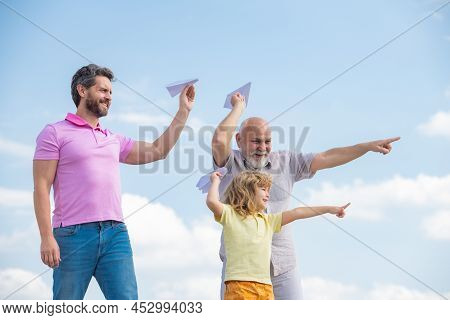Fathers Day. Kid Having Fun With Toy Plane. Men Generation Family With Three Different Generations A