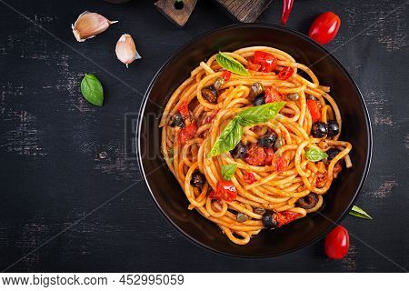 Spaghetti Alla Puttanesca - Italian Pasta Dish With Tomatoes, Black Olives, Capers, Anchovies And Ba
