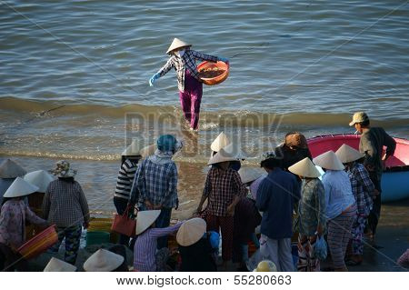 Crowd Of People Make Deal Fish At Seashore
