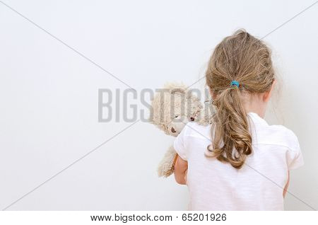 Little Girl Crying In The Corner. Domestic Violence Concept.
