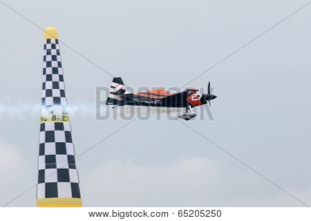 PUTRAJAYA, MALAYSIA - MAY 17, 2014: Nicolas Ivanoff from France in an Edge 540 V2 plane flies through the race course over Putrajaya lake at the Red Bull Air Race World Championship 2014.