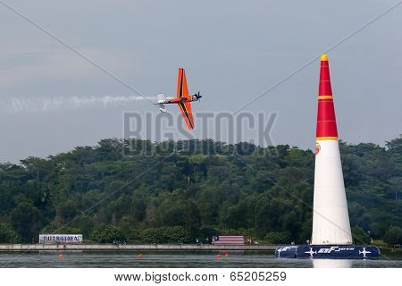 PUTRAJAYA, MALAYSIA - MAY 17, 2014: Nicolas Ivanoff from France in an Edge 540 V2 plane flies through the race course over Putrajaya lake at the Red Bull Air Race World Championship 2014.