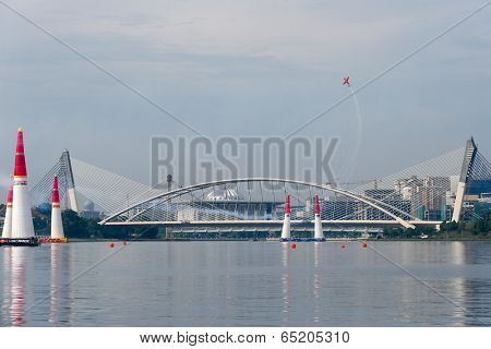 PUTRAJAYA, MALAYSIA - MAY 17, 2014: Nicolas Ivanoff from France in an Edge 540 V2 plane flies through the race course over Putrajaya lake at the Red Bull Air Race World Championship 2014.