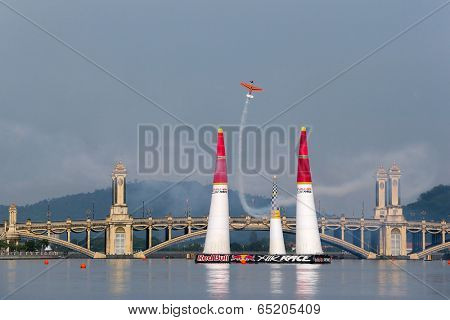 PUTRAJAYA, MALAYSIA - MAY 17, 2014: Nicolas Ivanoff from France in an Edge 540 V2 plane flies through the race course over Putrajaya lake at the Red Bull Air Race World Championship 2014.