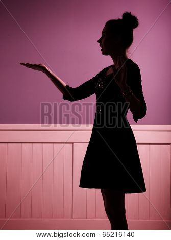 silhouette of a women showing something