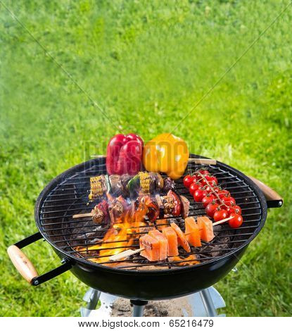 Meat and vegetable on barbecue grill with fire