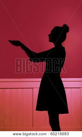 silhouette of a women showing something