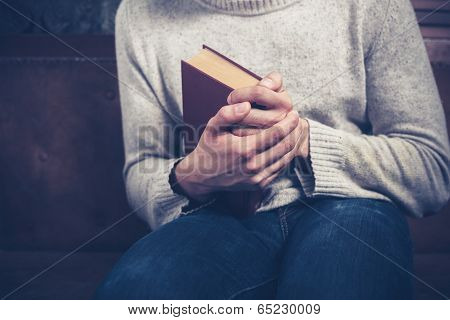 Nervous Young Man Clutching Book
