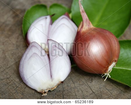 Sliced Shallot With Whole Shallots On Wooden