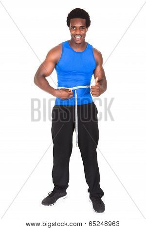 Bodybuilder With A Measuring Tape Around His Waist