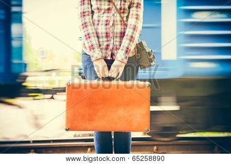 Young Woman With Retro Suitcase And Camera On Railway Platform