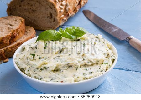 Herb Butter In A Bowl On Blue Wood