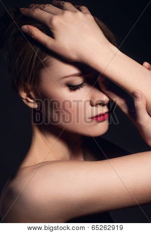 Portrait ob beautiful young woman on black background