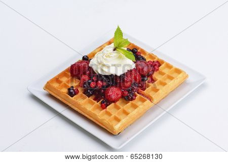 a selection of three italian gelato ice-cream scoops topped with nuts, chocolate, fruit served on crispy waffels