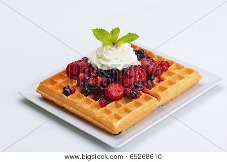a selection of three italian gelato ice-cream scoops topped with nuts, chocolate, fruit served on crispy waffels