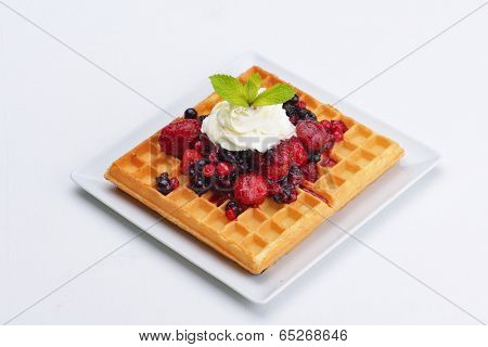 a selection of three italian gelato ice-cream scoops topped with nuts, chocolate, fruit served on crispy waffels