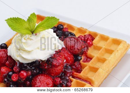 a selection of three italian gelato ice-cream scoops topped with nuts, chocolate, fruit served on crispy waffels