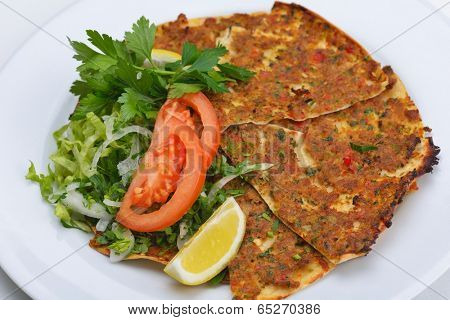 Homemade traditional Turkish meal pide stuffed with meat cheese,  and sauce isolated on white background